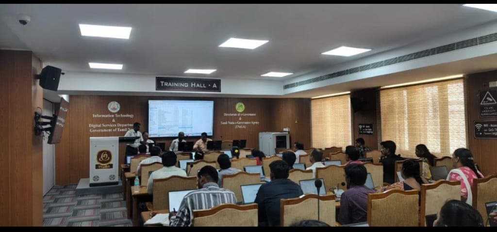 Training hall workshop with participants using laptops